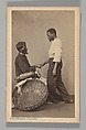 [Studio Portrait: Two Male Street Vendors in Profile, one Seated one Standing, Shaking Hands, Brazil], Christiano Junior (Portuguese, active Argentina, 1832–1902), Albumen silver print