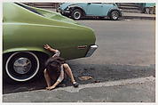 [Girl Playing Under Green Car, New York City], Helen Levitt  American, Dye transfer print