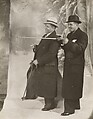 [Two Men in Overcoats, One Gesturing with Cane, Posed in Front of Painted Backdrop], James Van Der Zee  American, Gelatin silver print