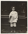 Jo Lehman, a 7 year old newsboy. 824 Third Ave., N.Y. City. He was selling in this Saloon. I asked him about the badge he was wearing.  "Oh! Dat's me bruder's," he said. Location: New York, New York., Lewis Hine  American, Gelatin silver print