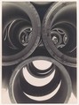 [Water Pipe Abstraction; View through Circular Ends of 3 Stacked Pipes onto Rows of Stacked Pipes in Background], Brett Weston  American, Gelatin silver print