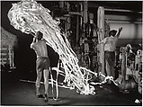 [Paper Mill Worker Removing Waste from Machine], Harold Edgerton  American, Gelatin silver print
