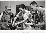 Mme. Chaing Kai-shek caring for the wounded. Hankow, Robert Capa  American, born Hungary, Gelatin silver print