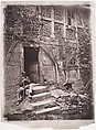 [Man Sitting on Steps of House with Socks Hanging on Nearby Vine to Dry], Unknown, Collotype