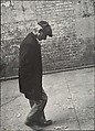 [Elderly Man in Dark Jacket and Cap Walking on Street, New York], Leon Levinstein  American, Gelatin silver print