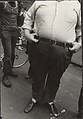 [Street Scene: Portly Man Holding Belt, New York City], Leon Levinstein  American, Gelatin silver print