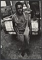 [Shoeless Man Standing Behind Pick-up Ttruck, Haiti], Leon Levinstein (American, Buckhannon, West Virginia 1910–1988 New York), Gelatin silver print
