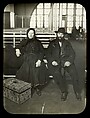 [Couple seated in the Main Hall, Ellis Island, New York], Lewis Hine  American, Lantern slide