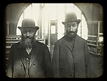 [Two Men Standing in the Main Hall, Ellis Island, New York], Lewis Hine  American, Lantern slide