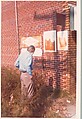 [Walker Evans in Front of Brick Wall with Commercial Signs, Alabama], William Christenberry  American, Chromogenic print