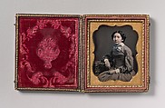 [Seated Young Woman Wearing Collar with Large Bow, Resting Arm on Table], Unknown (American), Daguerreotype with applied color