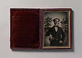 [Man Holding Book, Standing Before a Painted Scenic Backdrop], Unknown (British), Ambrotype with applied color