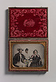 [Two Men, One in Military Garb, and a Woman, Seated Around a Table], Unknown (American), Ambrotype with applied color