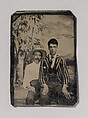 [Young Man in a Striped Jacket, Sitting on the Lap of Another Man in Front of Painted Outdoor Backdrop], Unknown (American), Tintype