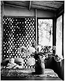 [Vase of Flowers on Table, Blurred View of Boy in Background], Ralph Eugene Meatyard  American, Gelatin silver print
