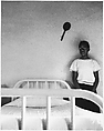 [Girl Standing Next to Bed, Racket on Wall], Ralph Eugene Meatyard  American, Gelatin silver print