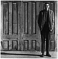 [Man Standing in Front of Three Wooden Doors], Ralph Eugene Meatyard  American, Gelatin silver print