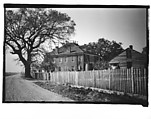 [Side View of Brick House Behind Picket Fence, From Automobile, Louisiana], Walker Evans  American, Film negative