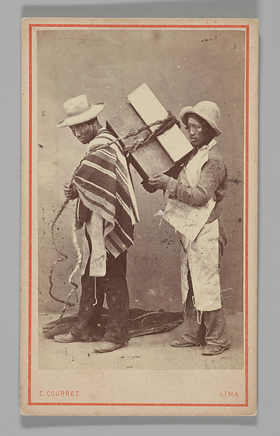 [Studio Portrait: Two Men, one with Box Tied to his Back, Lima]