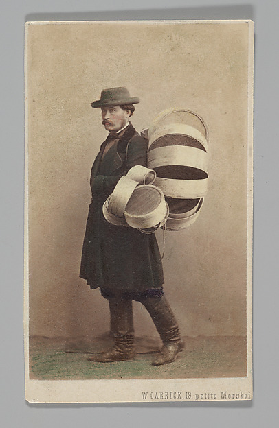 [Studio Portrait: Man in Coat Carrying Baskets, St. Petersburg]