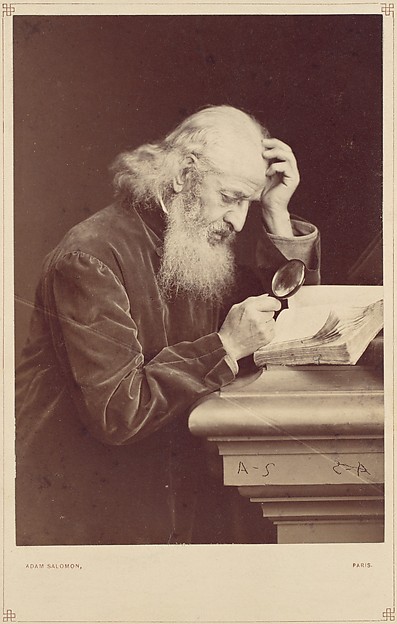 [Bearded Man with Magnifying Glass Examining a Manuscript]