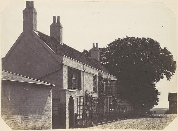 [House with Woman on Balcony, Man Standing Below]