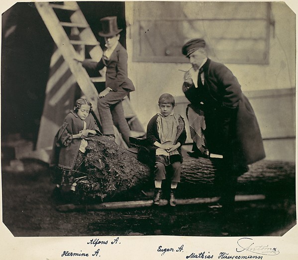 [Hermine, Alfons and Eugen Antoine and Mathias Häusermann on a fallen tree]