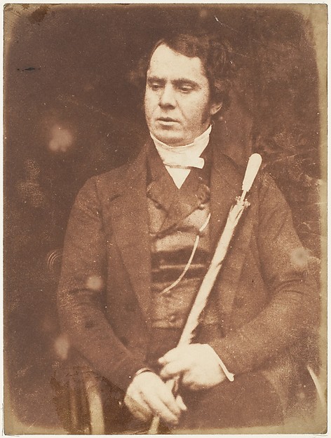 [Man Holding Umbrella]