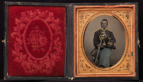 [Union Cavalry Officer Displaying Sword, Holding Hat, Seated in Studio]