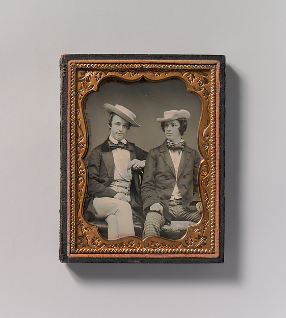 [Two Seated Young Men Wearing Gingham Trousers, Bow Ties, and Brimmed, Soft Hats]