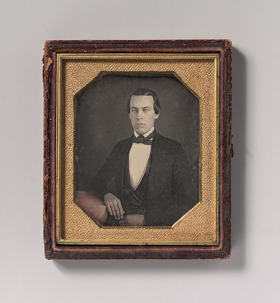 [Seated Young Man with Arm Resting on Table]