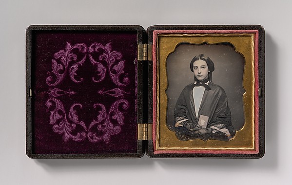 [Young Woman Wearing Lace Gloves Holding a Daguerreotype Case]
