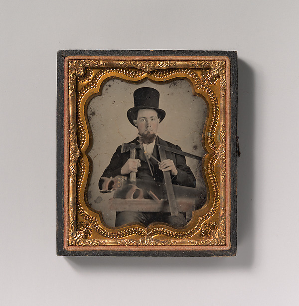 [Carpenter in Top Hat with Hatchet, Compass, Square, and Hand Saw]