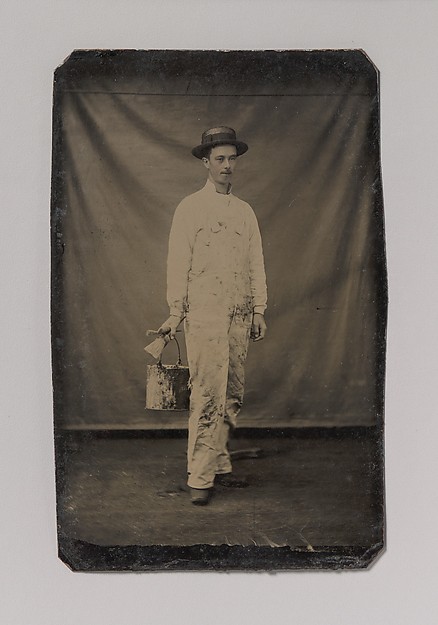 [Painter in Paint-spattered Overalls with Brushes and Paint Can]