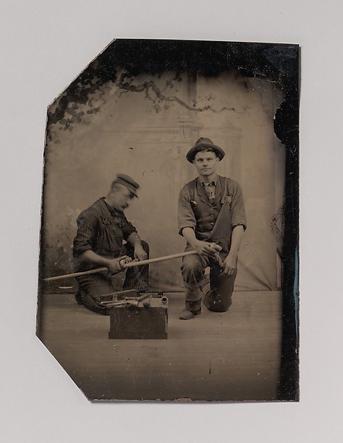 [Two Plumbers with a Pipe, Pipe Cutter, and Toolbox]