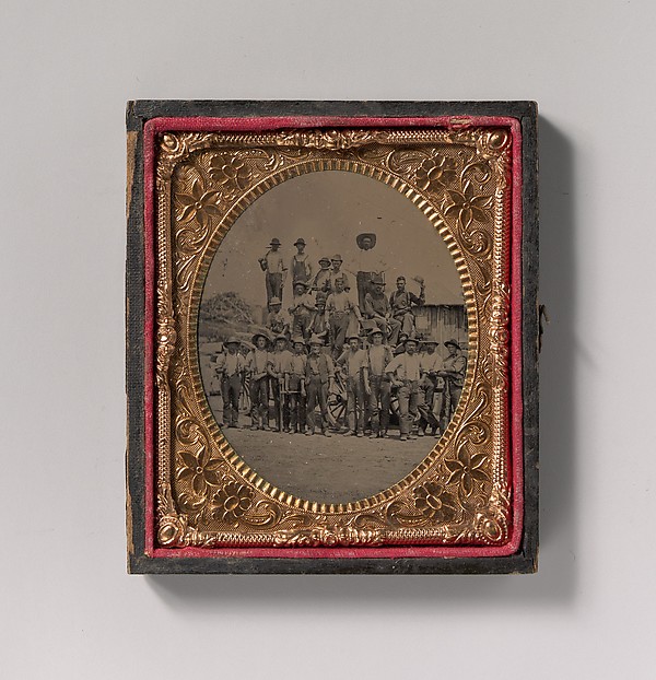 [Crew of Twenty-one Workmen Posing With Tools Outdoors]