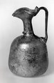Ewer, Transparent pale green glass, the handle perhaps somewhat darker. Blown, rim finished at the furnace, trails and handle applied., Roman