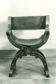 Hip-joint armchair (Dantesca type), Elm (?), bone, carved; leather (?), tooled embroidery, silk velvet, metal., Italian