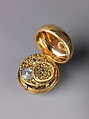 Watch Painted with a Pastoral Scene, Outer case of painted enamel on gold. Inner case of gold with an unidentified
maker’s mark consisting of the letters ic over b below a
coronet (incuse) on the interior and an eagle’s head, a French
guarantee mark for gold in use between 1 January 1847 and
1 July 1919 on the pendant. Dial of gold and white enamel
with black numerals; silver hands set with diamond chips.
Movement of gilt brass and steel. Movement signed (on the
back plate): Tomson/london., French and probably Swiss